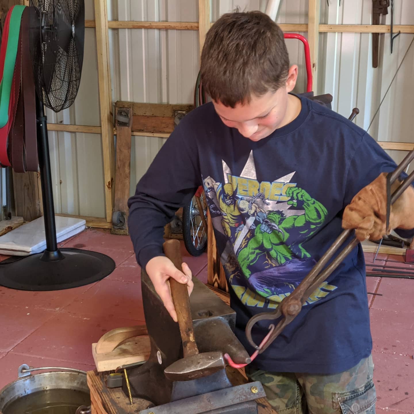 kid hammering iron